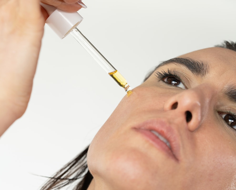Woman applying skincare products in the correct layering order